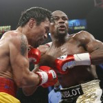 Manny Pacquiao, from the Philippines, left, and Floyd Mayweather Jr., trade blows during their welterweight title fight on Saturday, May 2, 2015 in Las Vegas. (AP Photo/John Locher)
