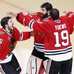 Chicago Blackhawks' goalie Corey Crawford, center, Jonathan Toews (19) and Andrew Shaw (65) celebrate after defeating the Tampa Bay Lightning in Game 6 of the NHL hockey Stanley Cup Final series on Monday, June 15, 2015, in Chicago. The Blackhawks defeated the Lightning 2-0 to win the series 4-2. (AP Photo/Charles Rex Arbogast)
