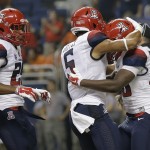 Arizona's Nick Wilson, right, celebrates with teammates after he rushed for a touchdown against UTSA during the first half of an NCAA college football game, Thursday, Sept. 4, 2014, in San Antonio. (AP Photo/Eric Gay)