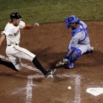 San Francisco Giants' Hunter Pence scores on an RBI double by Juan Perez as Kansas City Royals' Salvador Perez misses the tag during the eighth inning of Game 5 of baseball's World Series Sunday, Oct. 26, 2014, in San Francisco. (AP Photo/Marcio Jose Sanchez)