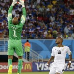 United States' goalkeeper Tim Howard, left, makes a save in front of Ghana's Andre Ayew during the group G World Cup soccer match between Ghana and the United States at the Arena das Dunas in Natal, Brazil, Monday, June 16, 2014. (AP Photo/Petr David Josek)
