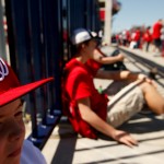 Jack Lewis, 12, of Arlington, Va., left, waits for the stadium to open at the center field gate before a baseball game between the Washington Nationals and the New York Mets on opening day at at Nationals Park, Monday, April 6, 2015, in Washington. (AP Photo/Andrew Harnik)