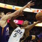 Utah Jazz' Rodney Hood, right, tries to shoot over Phoenix Suns Alex Len during the second half of an NBA basketball game in Salt Lake City, Saturday, Nov. 1, 2014. The Jazz defeated the Suns 118-91. (AP Photo/George Frey)