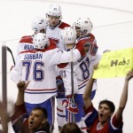 As Montreal Canadiens fans celebrate, Canadiens' Lars Eller (81), of Denmark, is congratulated on his goal against the Arizona Coyotes by teammates P.K. Subban (76), Jacob De La Rose (25), of Sweden, Andrei Markov (79), of Russia, and Devante Smith-Pelly, right, during the second period of an NHL hockey game Saturday, March 7, 2015, in Glendale, Ariz. (AP Photo/Ross D. Franklin)
