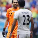  Iran's goalkeeper Alireza Haghighi gestures to teammate Mehrdad Pouladi after Bosnia scored its second goal during the group F World Cup soccer match between Bosnia and Iran at the Arena Fonte Nova in Salvador, Brazil, Wednesday, June 25, 2014. (AP Photo/Martin Mejia)