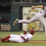 Philadelphia Phillies' Freddy Galvis, bottom, slides under Arizona Diamondbacks shortstop Nick Ahmed, top, while stealing second base with the ball going into the outfield during the first inning of a baseball game, Saturday, May 16, 2015, in Philadelphia. (AP Photo/Chris Szagola)