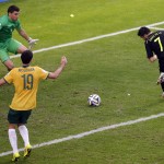 Spain's David Villa, right, scores his side's first goal during the group B World Cup soccer match between Australia and Spain at the Arena da Baixada in Curitiba, Brazil, Monday, June 23, 2014. (AP Photo/Michael Sohn)