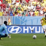 Colombia's Juan Quintero, right, kicks the ball past Ivory Coast's goalkeeper Boubacar Barry to score his sides's second goal during the group C World Cup soccer match between Colombia and Ivory Coast at the Estadio Nacional in Brasilia, Brazil, Thursday, June 19, 2014. (AP Photo/Fernando Llano)
