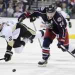 Columbus Blue Jackets' Mark Letestu, right, chases a loose puck as Pittsburgh Penguins' Matt Niskanen falls to the ice during the second period of Game 4 of a first-round NHL hockey playoff series on Wednesday, April 23, 2014, in Columbus, Ohio. (AP Photo/Jay LaPrete)