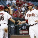 Arizona Diamondbacks' Chris Owings, left, and Roger Kieschnick, right, shake hands after both scored runs against the Milwaukee Brewers during the second inning of a baseball game on Monday, June 16, 2014, in Phoenix. (AP Photo/Ross D. Franklin)