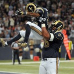 St. Louis Rams wide receiver Tavon Austin, left, is picked up by teammate Rodger Saffold after scoring on an 18-yard touchdown run during the first quarter of an NFL football game against the Oakland Raiders Sunday, Nov. 30, 2014, in St. Louis. (AP Photo/L.G. Patterson)