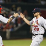 St. Louis Cardinals' Trevor Rosenthal (26) celebrates with catcher Yadier Molina, left, after the final out against the Arizona Diamondbacks in the 10th inning of a baseball game Friday, Sept. 26, 2014, in Phoenix. The Cardinals defeated the Diamondbacks 7-6 in 10 innings. (AP Photo/Ross D. Franklin)