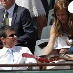 French Prime Minister Manuel Valls, left, attends Serbia's Novak Djokovic playing Switzerland's Stan Wawrinka during their final match of the French Open tennis tournament at the Roland Garros stadium, Sunday, June 7, 2015 in Paris. (AP Photo/Francois Mori)
