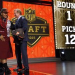 Washington defensive lineman Danny Shelton celebrates with NFL commissioner Roger Goodell after being selected by the Cleveland Browns as the 12th pick in the first round of the 2015 NFL Draft, Thursday, April 30, 2015, in Chicago. (AP Photo/Charles Rex Arbogast)