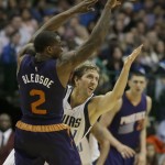 Dallas Mavericks forward Dirk Nowitzki (41) tries to defend Phoenix Suns guard Eric Bledsoe (2) during the second half of an NBA basketball game Friday, Dec. 5, 2014, in Dallas. The Suns won 118-106. (AP Photo/LM Otero)
