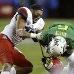 Arizona's Jourdon Grandon, left, loses his helmet as he tackles Oregon's Charles Nelson (6) during the first half of a Pac-12 Conference championship NCAA college football game Friday, Dec. 5, 2014, in Santa Clara, Calif. (AP Photo/Ben Margot)