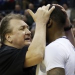 West Virginia head coach Bob Huggins talks to Elijah Macon in the first half of an NCAA tournament college basketball game against Buffalo in the Round of 64 in Columbus, Ohio Friday, March 20, 2015. (AP Photo/Paul Vernon)