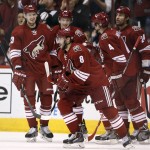 Arizona Coyotes' Tobias Rieder (8), of Germany, is surrounded by teammates Oliver Ekman-Larsson (23), of Sweden, Zbynek Michalek (4), of the Czech Republic, Kyle Chipchura (24) and Lauri Korpikoski after Rieder's goal against the Columbus Blue Jackets during the first period of an NHL hockey game Saturday, Jan. 3, 2015, in Glendale, Ariz. (AP Photo/Ross D. Franklin)