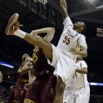  Texas center Cameron Ridley (55) grabs on to the rim as he misses a dunk against Arizona State center Jordan Bachynski (13) during the second half of a second-round game in the NCAA college basketball tournament Thursday, March 20, 2014, in Milwaukee. (AP Photo/Morry Gash)