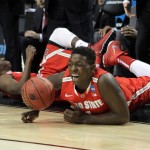 Ohio's State's Jae'Sean Tate, right, and Shannon Scott dive to keep a ball in bounds during an NCAA college basketball tournament round of 32 game against Arizona in Portland, Ore., Saturday, March 21, 2015. (AP Photo/Craig Mitchelldyer)