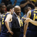 California head coach Cuonzo Martin, center, speaks with his team during a time out in the second half of an NCAA college basketball game against Arizona in the quarterfinals of the Pac-12 conference tournament Thursday, March 12, 2015, in Las Vegas. Arizona won 73-51. (AP Photo/John Locher)