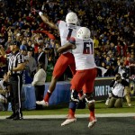 Arizona offensive lineman Cayman Bundage (61) celebrates a touchdown by wide receiver Cayleb Jones (1) during the first half of an NCAA college football game against UCLA, Saturday, Nov. 1, 2014, in Pasadena, Calif. (AP Photo/Gus Ruelas)