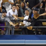 Fans try to catch a solo home run by Arizona Diamondbacks' Yasmany Tomas during the fifth inning of a baseball game against the Los Angeles Dodgers, Wednesday, June 10, 2015, in Los Angeles. (AP Photo/Mark J. Terrill)