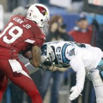 Carolina Panthers' Melvin White (23) hits Arizona Cardinals' Ted Ginn (19) in the second half of an NFL wild card playoff football game in Charlotte, N.C., Saturday, Jan. 3, 2015. Ginn fumbled the ball and the Panthers recovered. (AP Photo/Bob Leverone)