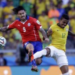 Chile's Mauricio Pinilla, left, and Brazil's Luiz Gustavo battle for the ball during the World Cup round of 16 soccer match between Brazil and Chile at the Mineirao Stadium in Belo Horizonte, Brazil, Saturday, June 28, 2014. (AP Photo/Andre Penner)