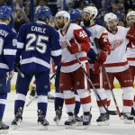 Tampa Bay Lightning center Vladislav Namestnikov (90), of Russia, and defenseman Matt Carle (25) shakes hands with Detroit Red Wings left wing Henrik Zetterberg (40), of Sweden, defenseman Kyle Quincey (27), center Pavel Datsyuk (13), of Russia, and left wing Drew Miller (20) shake hands after the Lightning defeated the Red Wings 2-0 during Game 7 of a first-round NHL Stanley Cup hockey playoff series Wednesday, April 29, 2015, in Tampa, Fla. (AP Photo/Chris O'Meara)