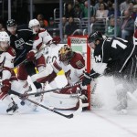 Los Angeles Kings left wing Dwight King, right, attempts to score but is stopped by Arizona Coyotes defenseman Brandon Gormley, left, and goalie Mike Smith during the second period of an NHL hockey game, Monday, March 16, 2015, in Los Angeles. (AP Photo/Danny Moloshok)