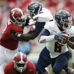 Florida Atlantic quarterback Greg Hankerson (6) slips through Alabama defense and looks to pass during the second half of an NCAA college football game Saturday, Sept. 6, 2014, in Tuscaloosa, Ala. (AP Photo/Brynn Anderson)
