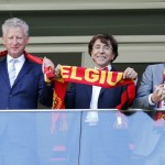 Belgian Prime Minister Elio Di Rupo, center, hold up a Belgium scarf before the World Cup quarterfinal soccer match between Argentina and Belgium at the Estadio Nacional in Brasilia, Brazil, Saturday, July 5, 2014. (AP Photo/Victor R. Caivano)