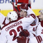 Arizona Coyotes' B.J. Crombeen, center, celebrates his goal against the Calgary Flames with teammate Craig Cunningham, left, and Oliver Ekman-Larsson, from Sweden, during the second period of an NHL hockey game, Tuesday, April 7, 2015 in Calgary, Alberta. (AP Photo/The Canadian Press, Larry MacDougal)