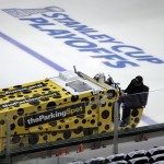 A member of the ice crew works the ice rink before a first-round NHL hockey Stanley Cup playoff series game between the Anaheim Ducks and Dallas Stars, Monday, April 21, 2014, in Dallas. (AP Photo/Tony Gutierrez)

