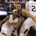 Phoenix Suns guard Isaiah Thomas (3) drives past Golden State Warriors guard Stephen Curry (30) on a pick by Miles Plumlee (22) during the second half of an NBA basketball game, Sunday, Nov. 9, 2014, in Phoenix. The Suns won 107-95. (AP Photo/Rick Scuteri)