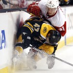 Boston Bruins defenseman Torey Krug (47) stops Detroit Red Wings' Luke Glendening (41) from getting around him during the first period of Game 2 of a first-round NHL hockey playoff series in Boston, Sunday, April 20, 2014. (AP Photo/Winslow Townson)