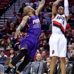 Portland Trail Blazers guard Arron Afflalo, right, shoots over Phoenix Suns forward P.J. Tucker, left, during the third quarter of an NBA basketball game in Portland, Ore., Monday, March 30, 2015. (AP Photo/Craig Mitchelldyer)