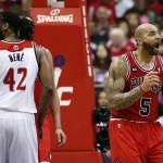 Chicago Bulls forward Carlos Boozer (5) reacts to a foul call, with Washington Wizards forward Nene (42) nearby in the second half of Game 3 of an opening-round NBA basketball playoff series, Friday, April 25, 2014, in Washington. The Bulls won 100-97. (AP Photo/Alex Brandon)
