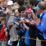 Young golf fans applaud as they wait for Rory McIlroy of Northern Ireland to pass by on the 17th hole during the third day of the British Open Golf championship at the Royal Liverpool golf club, Hoylake, England, Saturday July 19, 2014. (AP Photo/Jon Super)