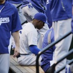 Los Angeles Dodgers right fielder Yasiel Puig, center, sits in the dugout during the third inning Game 4 of baseball's NL Division Series against the St. Louis Cardinals, Tuesday, Oct. 7, 2014, in St. Louis. (AP Photo/Charles Rex Arbogast)