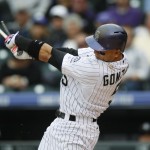 Colorado Rockies right fielder Carlos Gonzalez breaks his bat while flying out against the Arizona Diamondbacks to lead of the bottom of the seventh inning of the first game of a baseball doubleheader Wednesday, May 6, 2015, in Denver. (AP Photo/David Zalubowski)