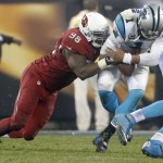 Carolina Panthers' Cam Newton (1) is tackled by Arizona Cardinals' Frostee Rucker (98) in the second half of an NFL wild card playoff football game in Charlotte, N.C., Saturday, Jan. 3, 2015. (AP Photo/Bob Leverone)