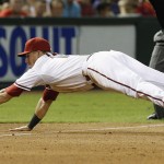 Arizona Diamondbacks' Jake Lamb dives to make a catch on a grounder by St. Louis Cardinals' Randal Grichuk during the fifth inning of a baseball game Friday, Sept. 26, 2014, in Phoenix. The ball was ruled a foul ball on the play. (AP Photo/Ross D. Franklin)