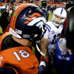 Denver Broncos quarterback Peyton Manning, left, and Indianapolis Colts quarterback Andrew Luck shake hands after an NFL divisional playoff football game, Sunday, Jan. 11, 2015, in Denver. The Colts won 24-13 to advance to the AFC Championship game against the New England Patriots. (AP Photo/Jack Dempsey)
