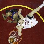 Cleveland Cavaliers Timofey Mozgov, right, from Russia, drives to the basket against Phoenix Suns' Markieff Morris in the first half of an NBA basketball game Saturday, March 7, 2015, in Cleveland. (AP Photo/Tony Dejak)
