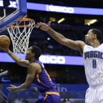 Phoenix Suns' T.J. Warren, left, slips by Orlando Magic's Channing Frye (8) for a basket during the first half of an NBA basketball game, Wednesday, March 4, 2015, in Orlando, Fla. (AP Photo/John Raoux)