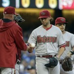  Arizona Diamondbacks starting pitcher Mike Bolsinger, center, hands the ball to manager Kirk Gibson, left, during the fifth inning of a baseball game against the Los Angeles Dodgers, Saturday, April 19, 2014, in Los Angeles. (AP Photo/Jae C. Hong)
