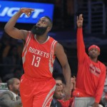 Houston Rockets guard James Harden, left, gestures after hitting a three point shot during the first half of an NBA basketball game against the Los Angeles Lakers, Tuesday, Oct. 28, 2014, in Los Angeles. (AP Photo/Mark J. Terrill)