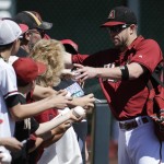 Arizona Diamondbacks second baseman Aaron Hill signs autographs before a spring exhibition baseball game against the Milwaukee Brewers in Scottsdale, Ariz., Sunday, March 16, 2014. (AP Photo/Chris Carlson)